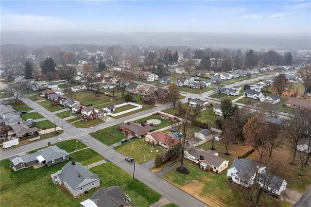 an aerial view of residential building with green space