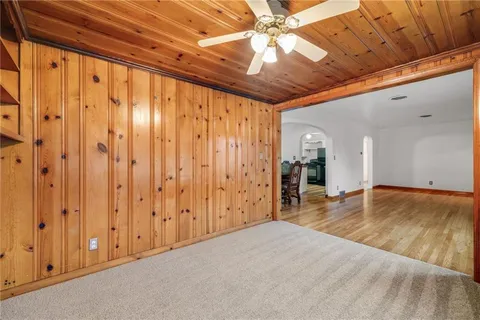 a view of a livingroom with wooden floor and a ceiling fan