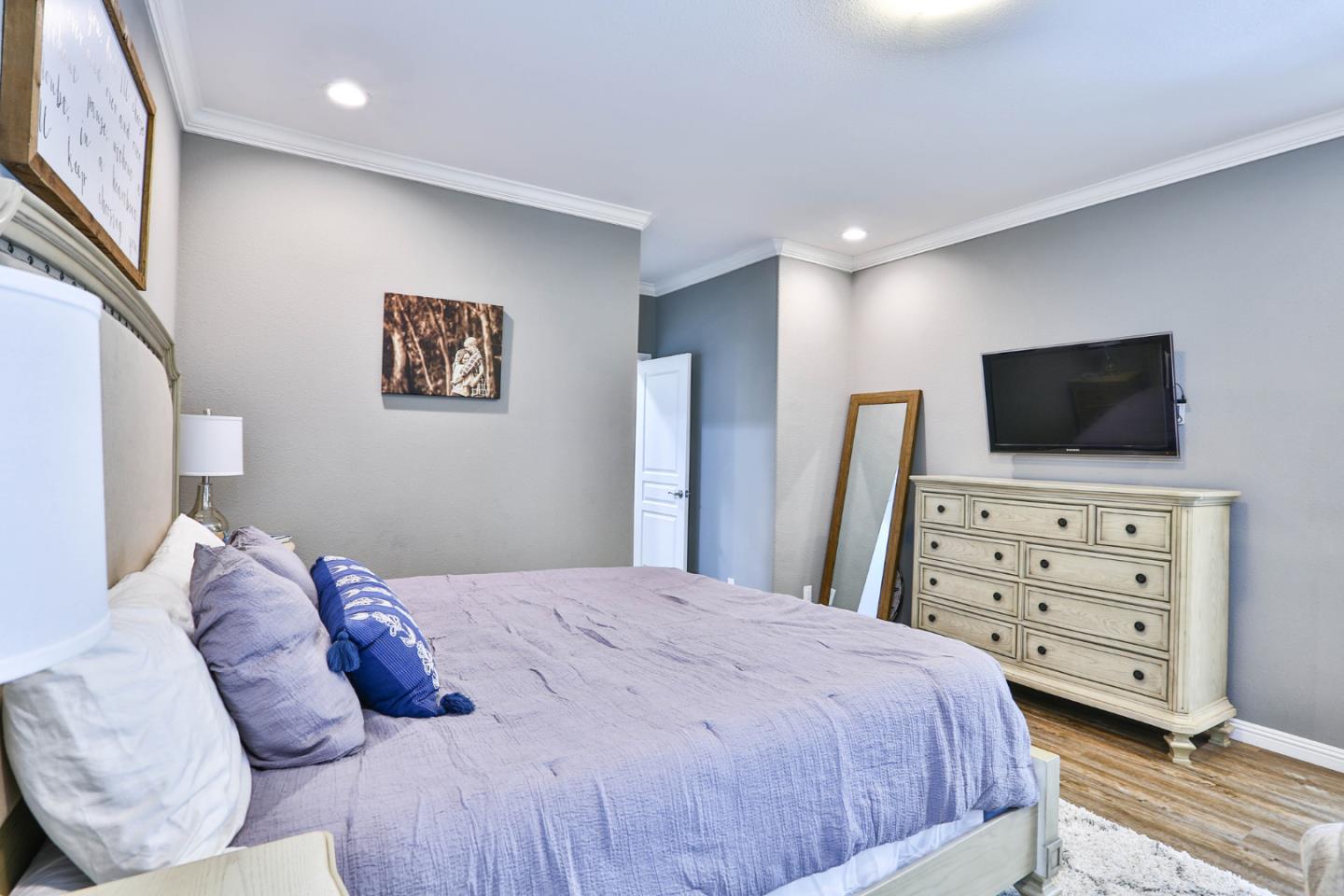 136 Timber Cove Drive, Unit 136 Campbell, CA 95008 - Photo 17 of 36 a bedroom with a bed and a flat screen tv