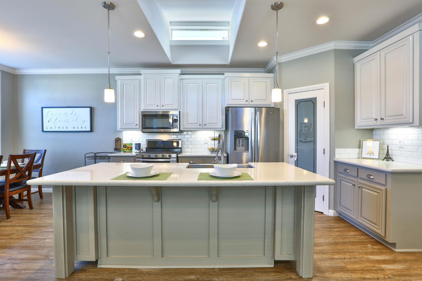 136 Timber Cove Drive, Unit 136 Campbell, CA 95008 - Photo 10 of 36 a kitchen with kitchen island stainless steel appliances a sink stove refrigerator and cabinets