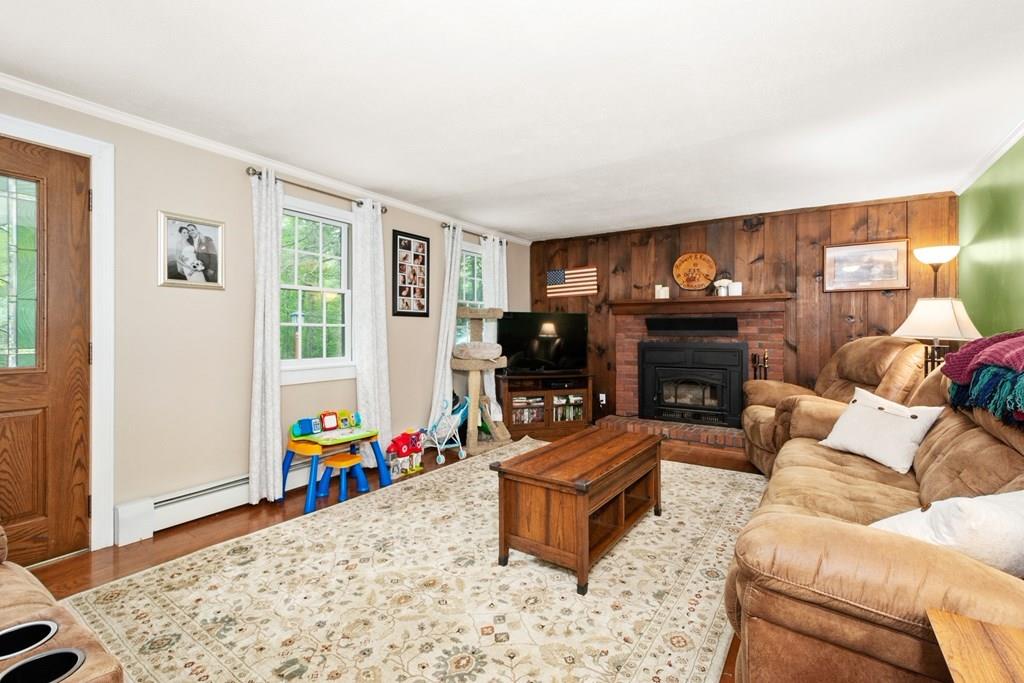 154 Shepard Road Sturbridge, MA 01566 - Photo 7 of 24 a living room with furniture a flat screen tv and a fireplace