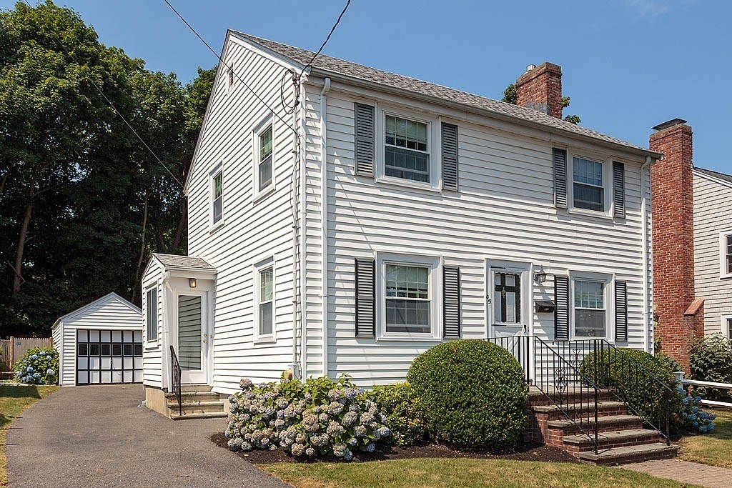 a view of a house with a small yard and plants