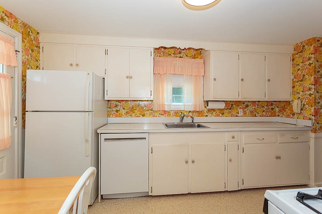 45 Magnolia Road Milton, MA 02186 - Photo 14 of 26 a kitchen with stainless steel appliances granite countertop a refrigerator a sink and white cabinets