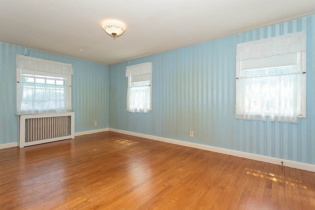 45 Magnolia Road Milton, MA 02186 - Photo 19 of 26 a view of an empty room with wooden floor and a window