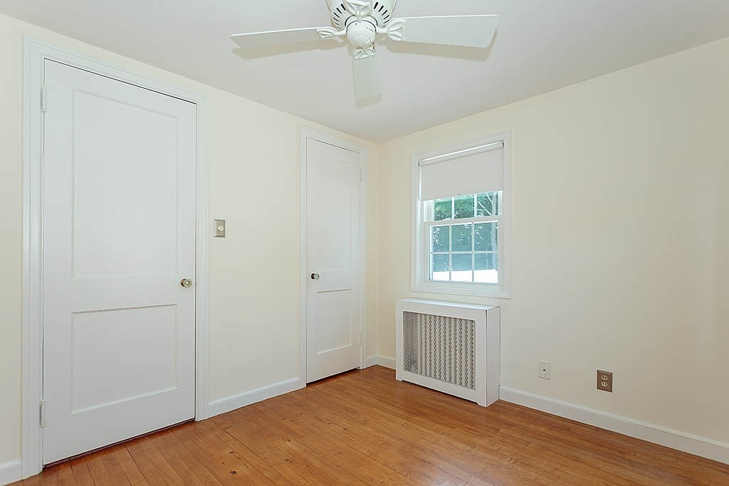 45 Magnolia Road Milton, MA 02186 - Photo 20 of 26 an empty room with wooden floor closet and windows