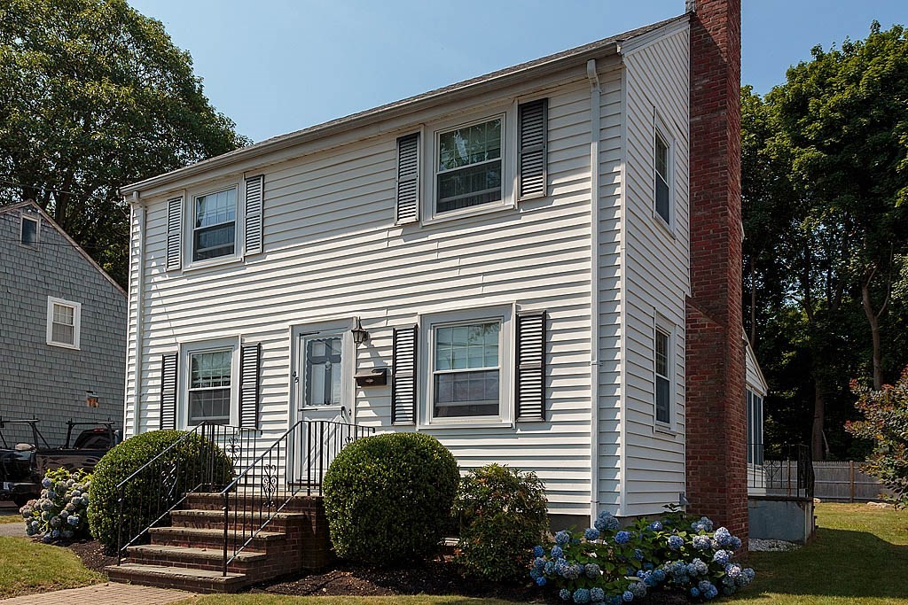 45 Magnolia Road Milton, MA 02186 - Photo 3 of 26 a front view of a house with a garden
