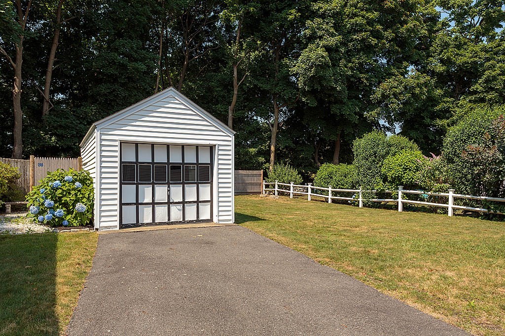 45 Magnolia Road Milton, MA 02186 - Photo 4 of 26 a view of a house with a yard and potted plants