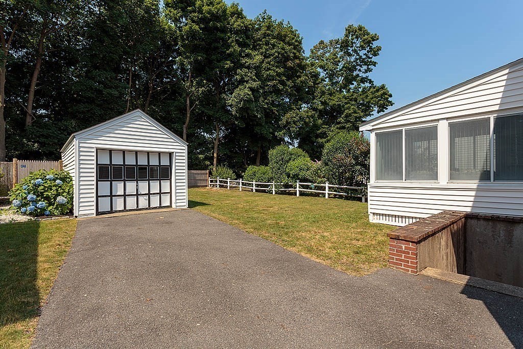 45 Magnolia Road Milton, MA 02186 - Photo 7 of 26 a front view of a house with a yard