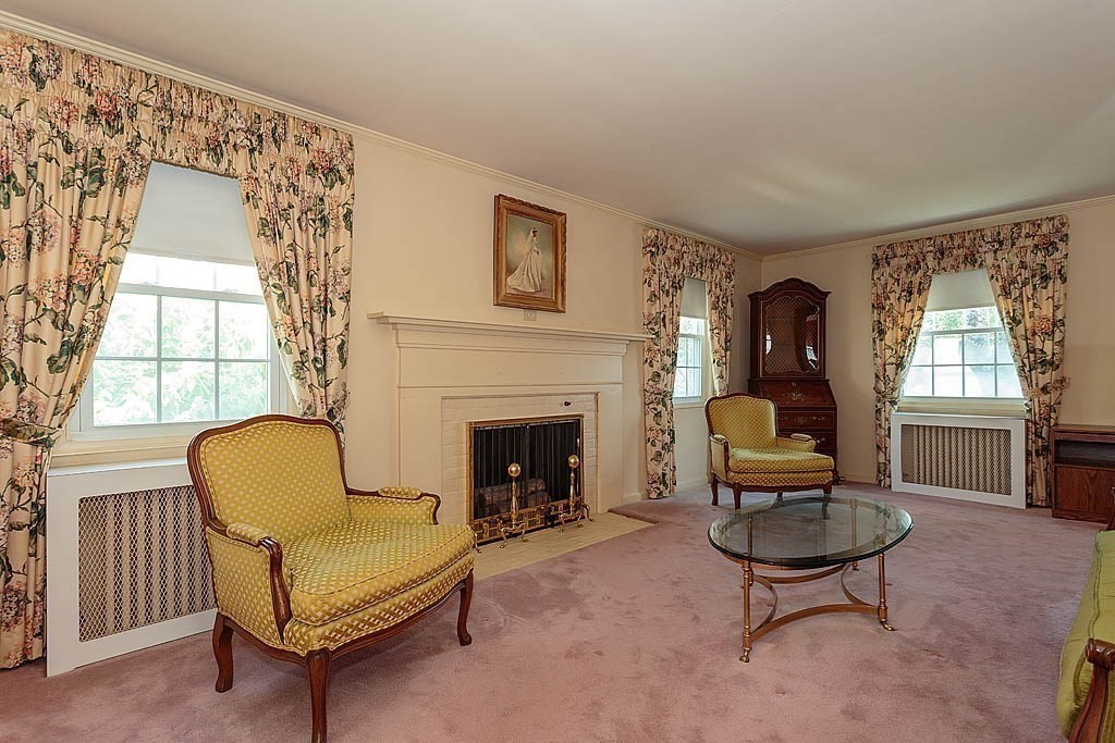 45 Magnolia Road Milton, MA 02186 - Photo 10 of 26 a living room with furniture a fireplace and a large window