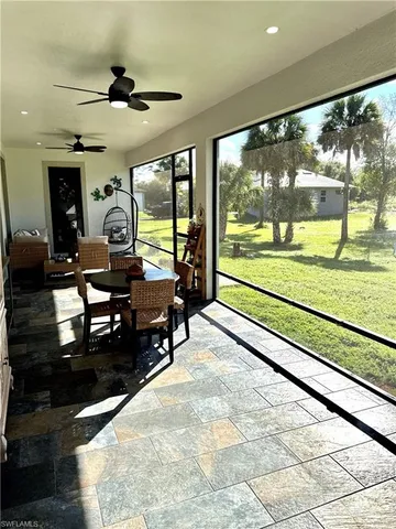 a view of an empty room with cabinet and a flat screen tv