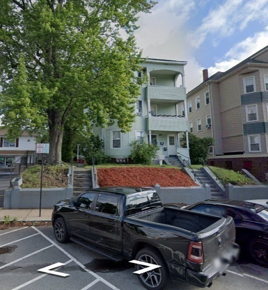 57 Hamilton Street, Unit 1 Worcester, MA 01604 - Photo 11 of 14 a view of a patio with table and chairs with wooden floor and fence