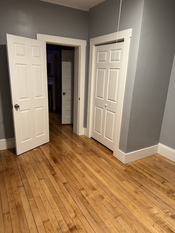 57 Hamilton Street, Unit 1 Worcester, MA 01604 - Photo 3 of 14 an empty room with wooden floor and closet