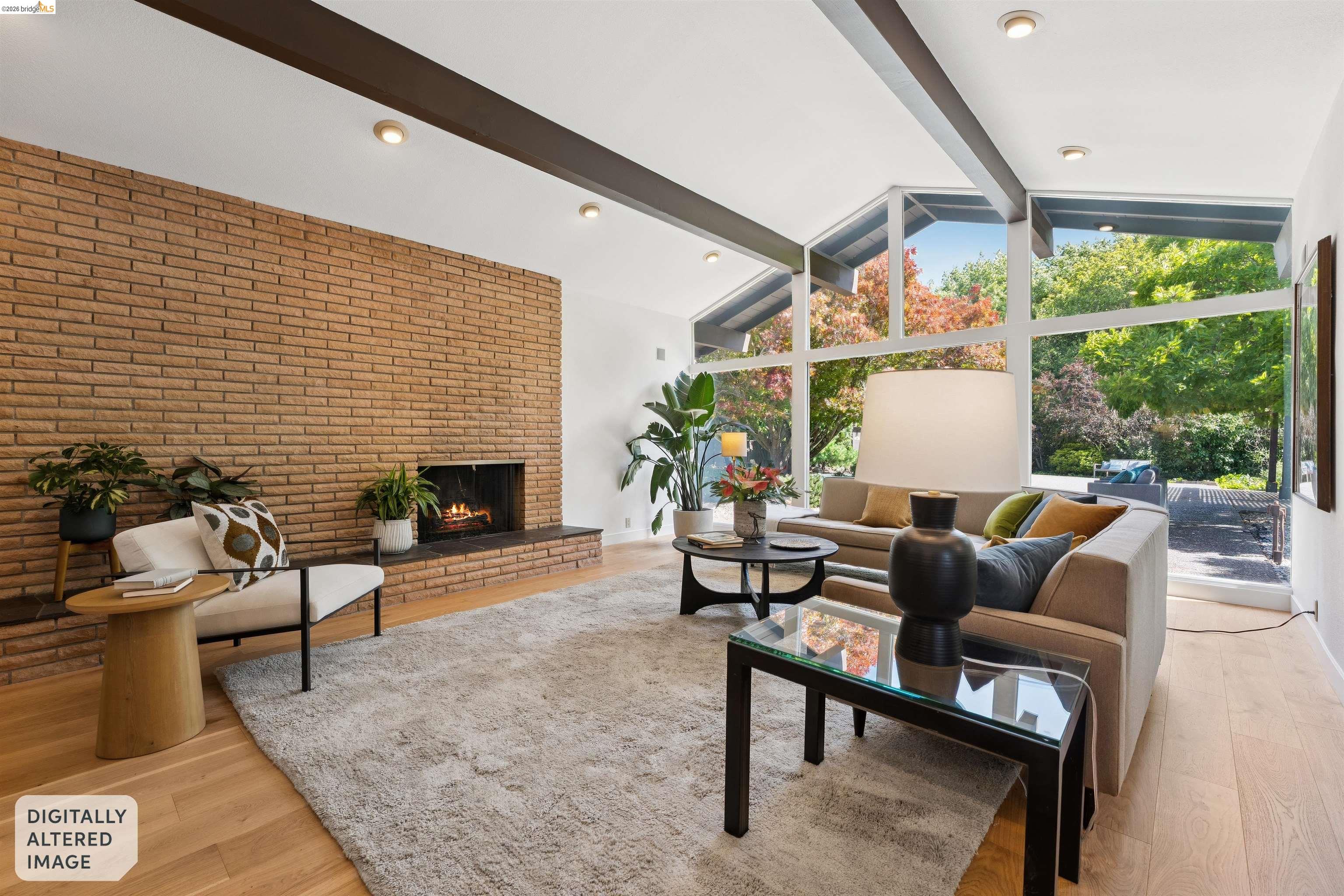 7 Jo Lin Court El Sobrante, CA 94803 - Photo 28 of 99 Vaulted ceiling living area featuring an exposed brick fireplace, light wood-finish flooring, and expansive windows