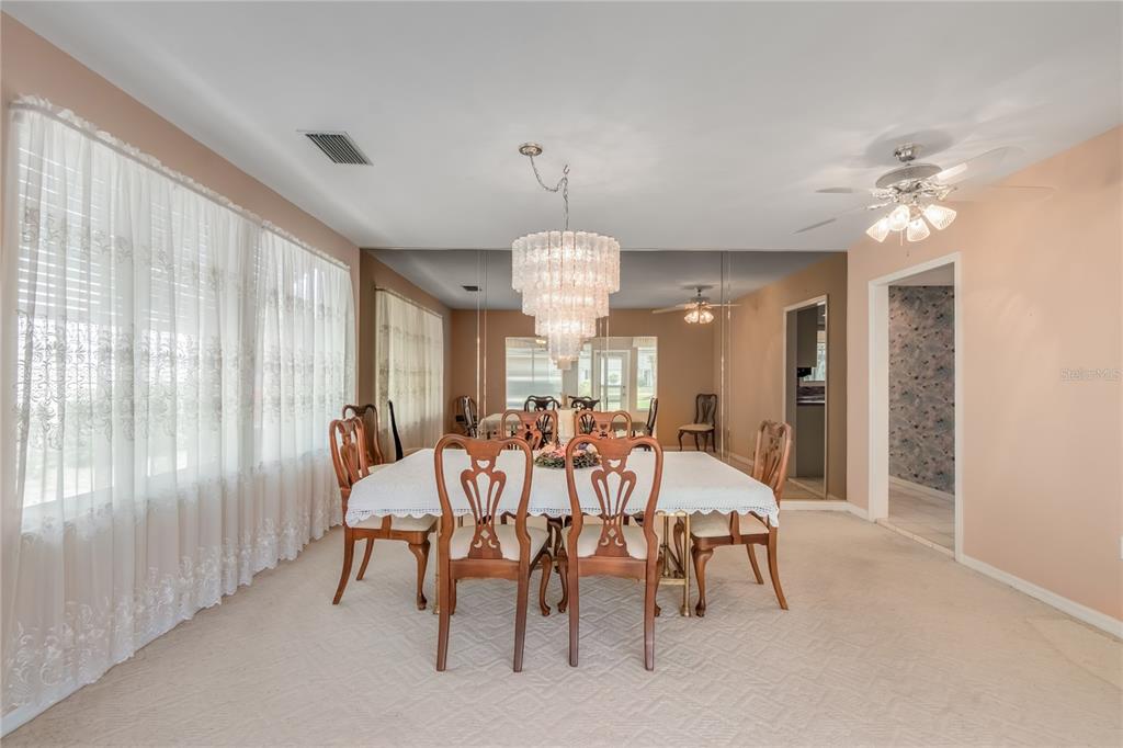 8156 Southwest 108th Ln Road Ocala, FL 34481 - Photo 13 of 50 a view of a dining room with furniture and chandelier