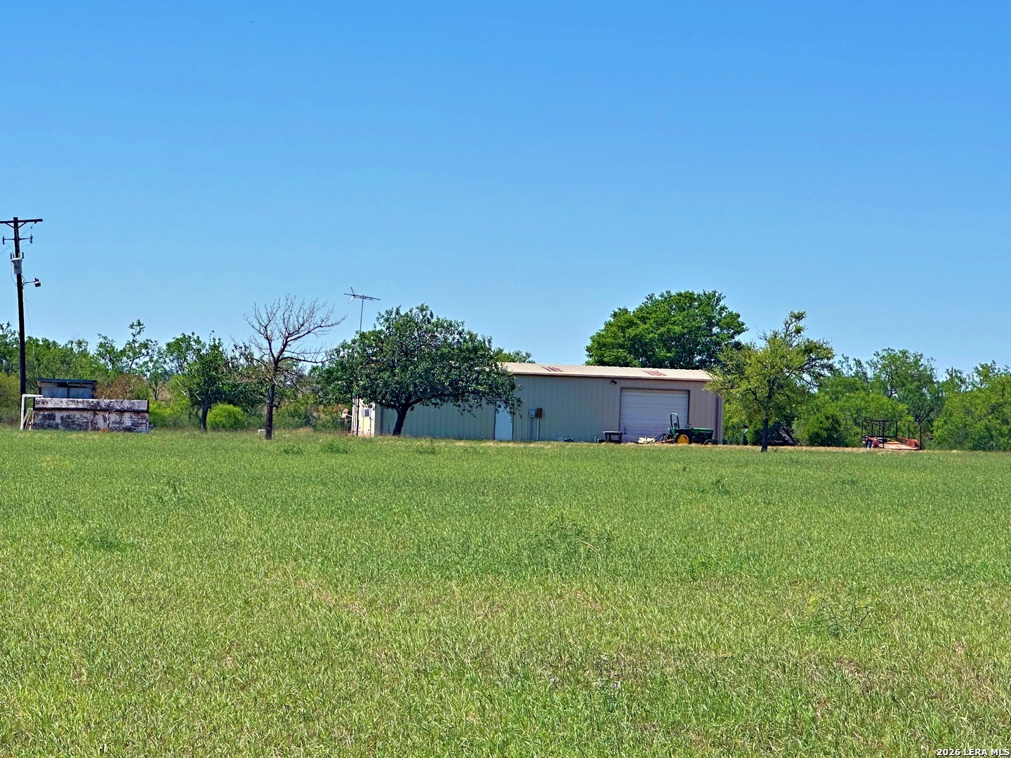 3265 Highway 97 Jourdanton, TX 78026 - Photo 3 of 23 a backyard of a house with lots of green space