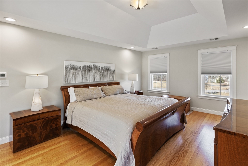 5 Box Mill Road Hopkinton, MA 01748 - Photo 25 of 42 a bedroom with a bed and wooden floor