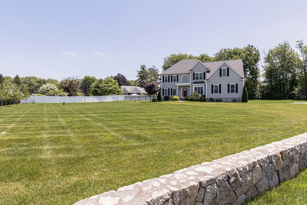 5 Box Mill Road Hopkinton, MA 01748 - Photo 3 of 42 a view of a lake with a house in the background