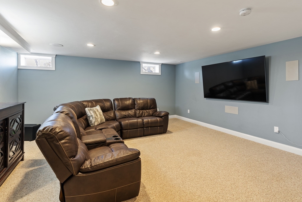 5 Box Mill Road Hopkinton, MA 01748 - Photo 35 of 42 a living room with furniture and a flat screen tv