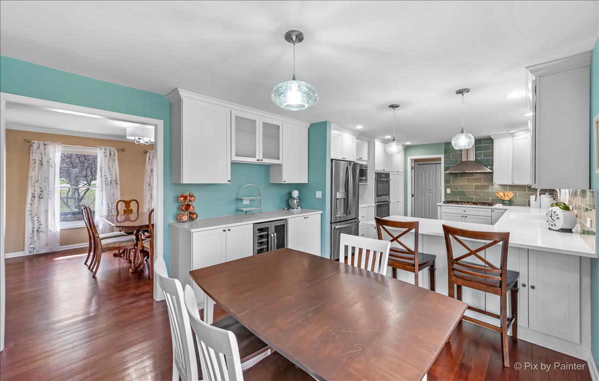 254 Perth Road Cary, IL 60013 - Photo 13 of 36 a kitchen with a dining table chairs stainless steel appliances and cabinets