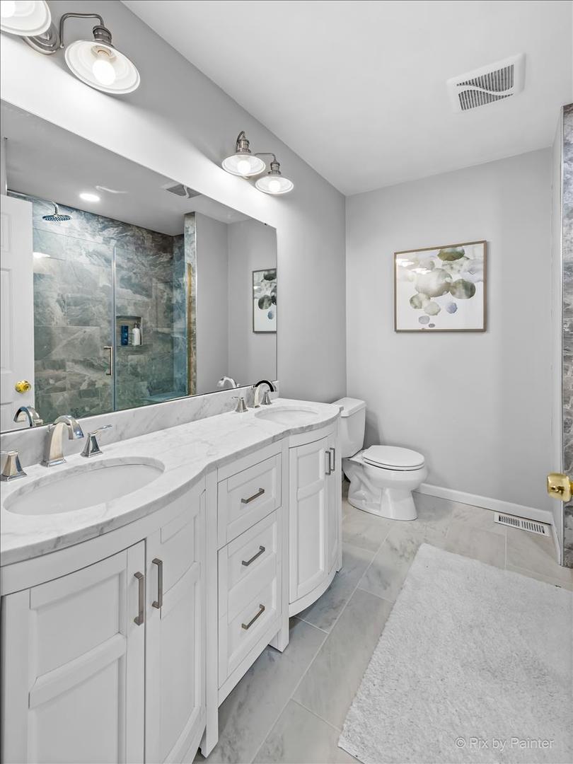 254 Perth Road Cary, IL 60013 - Photo 19 of 36 a bathroom with a double vanity sink mirror and toilet