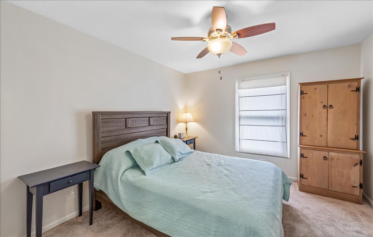 254 Perth Road Cary, IL 60013 - Photo 23 of 36 a bedroom with a bed and a ceiling fan