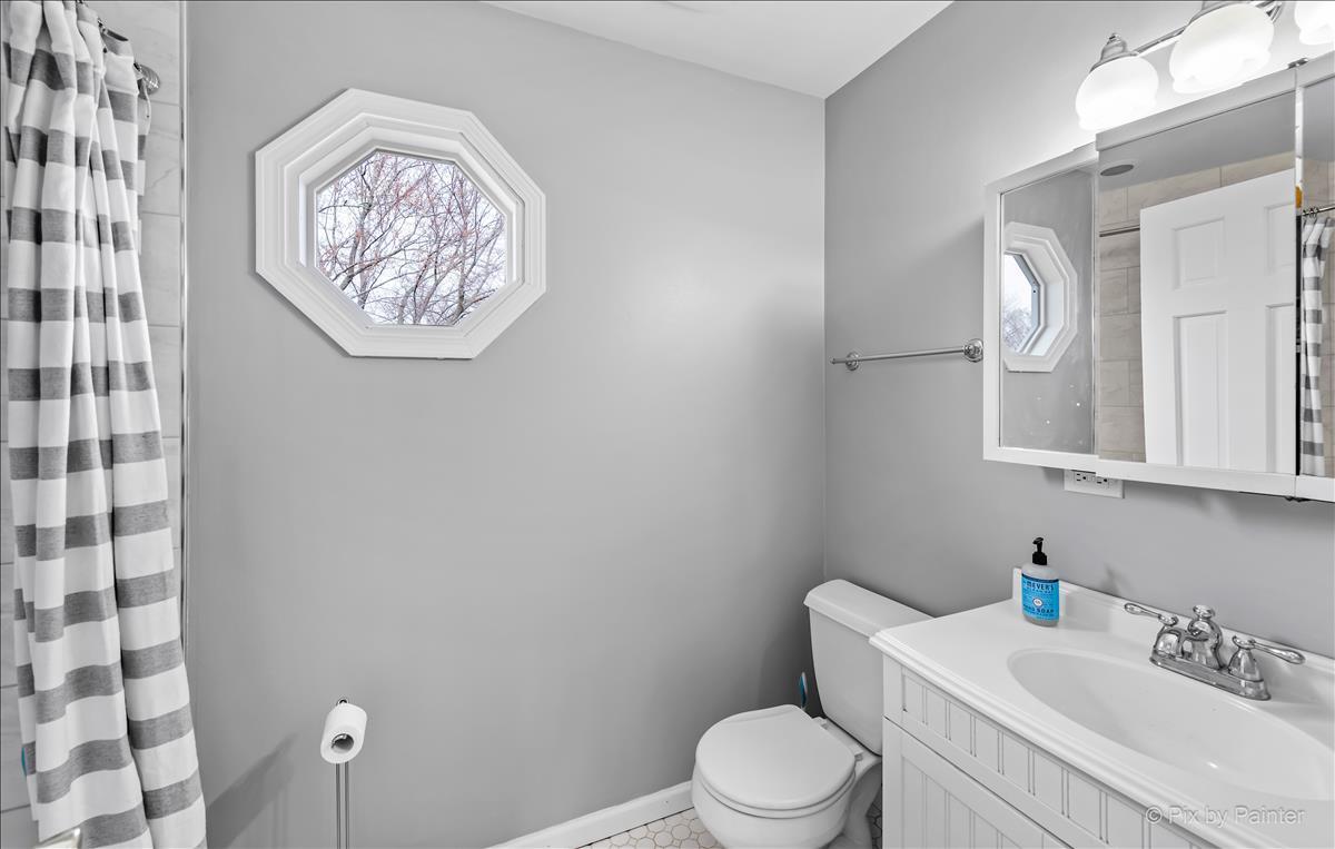 254 Perth Road Cary, IL 60013 - Photo 24 of 36 a white toilet sitting next to a bathroom sink