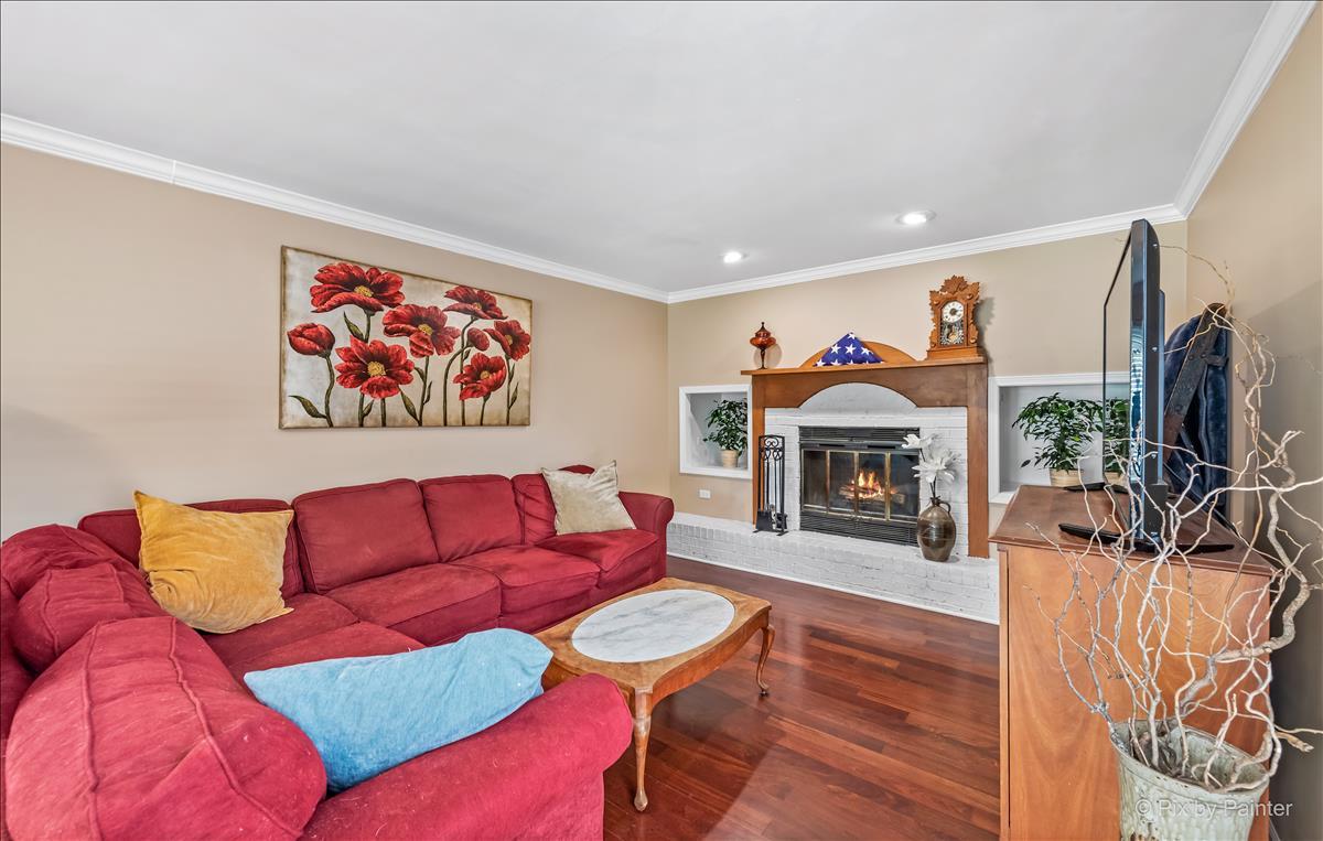 254 Perth Road Cary, IL 60013 - Photo 7 of 36 a living room with furniture a flat screen tv and a fireplace