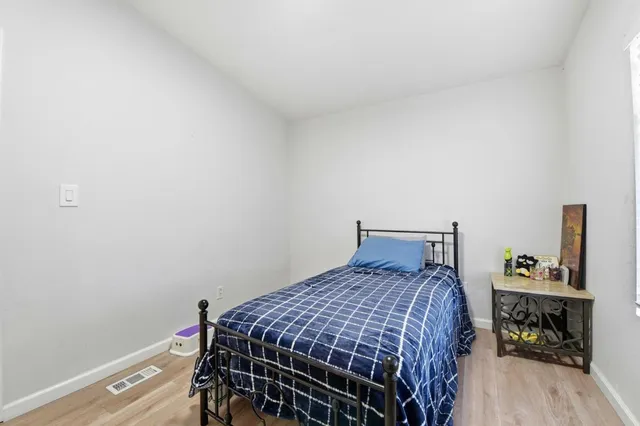 a bedroom with furniture and a window