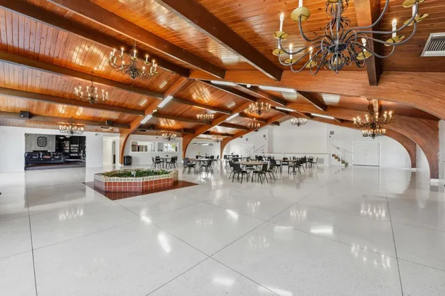 a room with pool table and windows