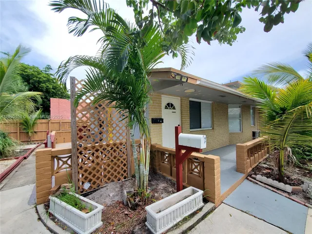 front view of a house with a tree