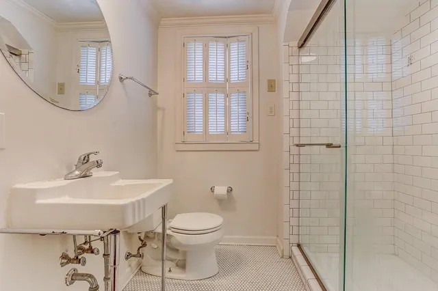 a kitchen with stainless steel appliances granite countertop a refrigerator a stove top oven a sink dishwasher and a dining table with wooden floor