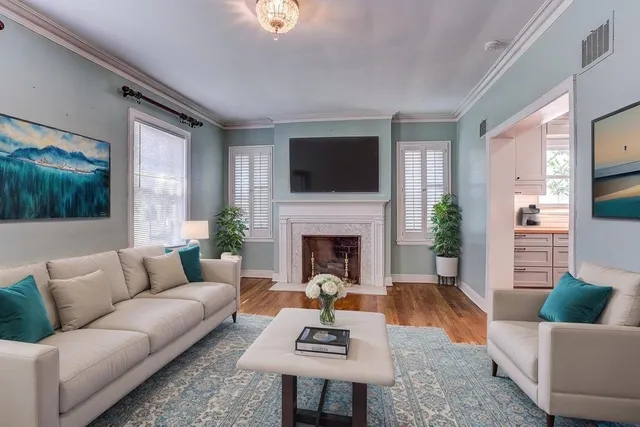 a living room with furniture a fireplace and a flat screen tv