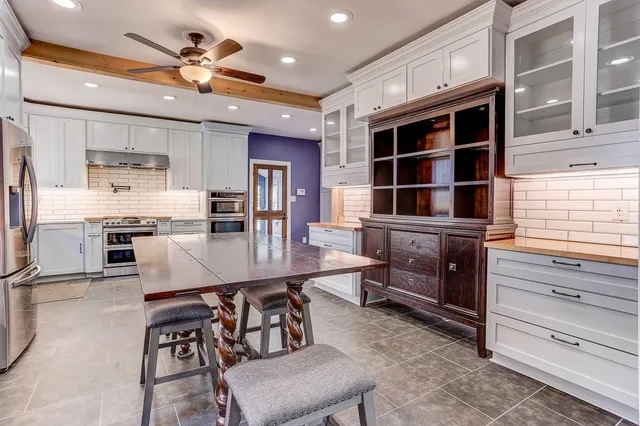 a kitchen with stainless steel appliances a stove sink and refrigerator