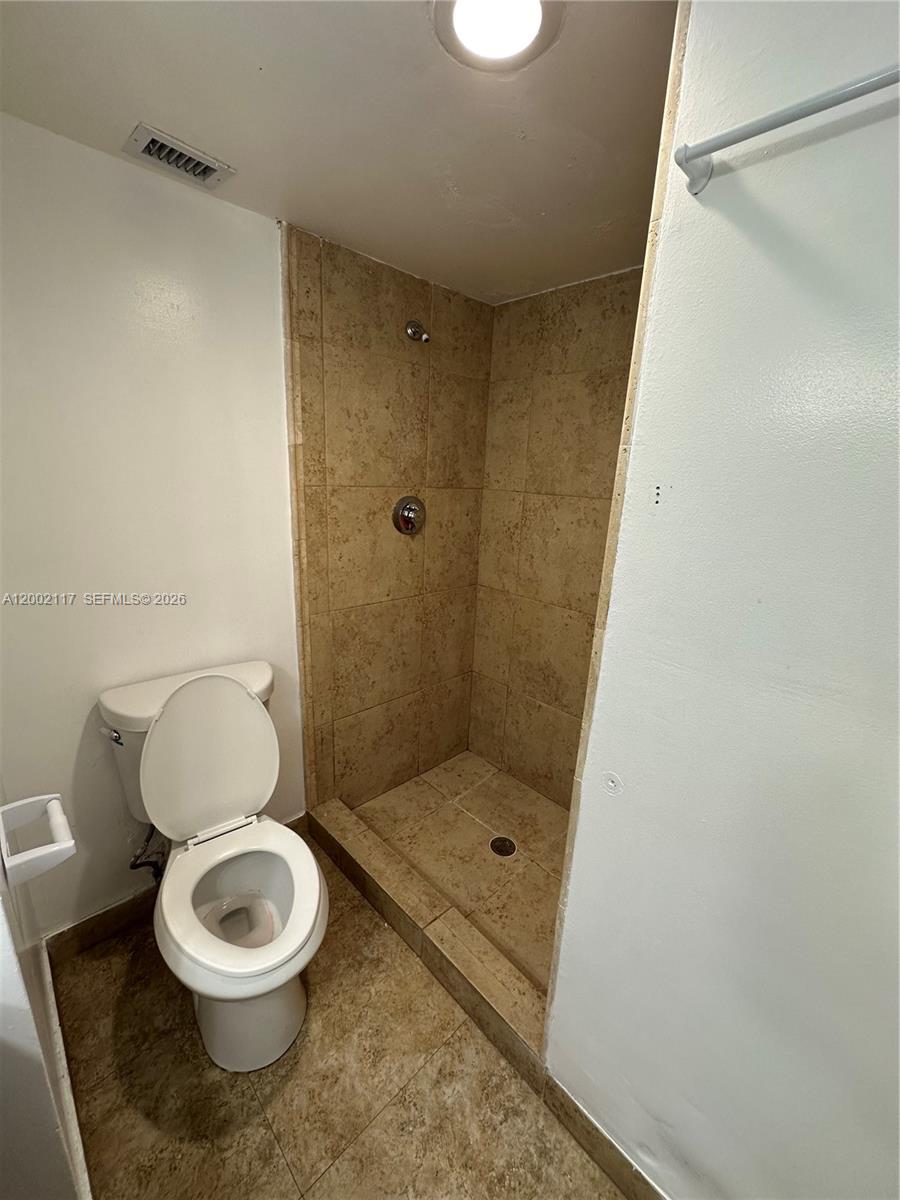9001 Southwest 77th Avenue, Unit C702 Miami, FL 33156 - Photo 9 of 11 a white toilet sitting next to a bathroom sink