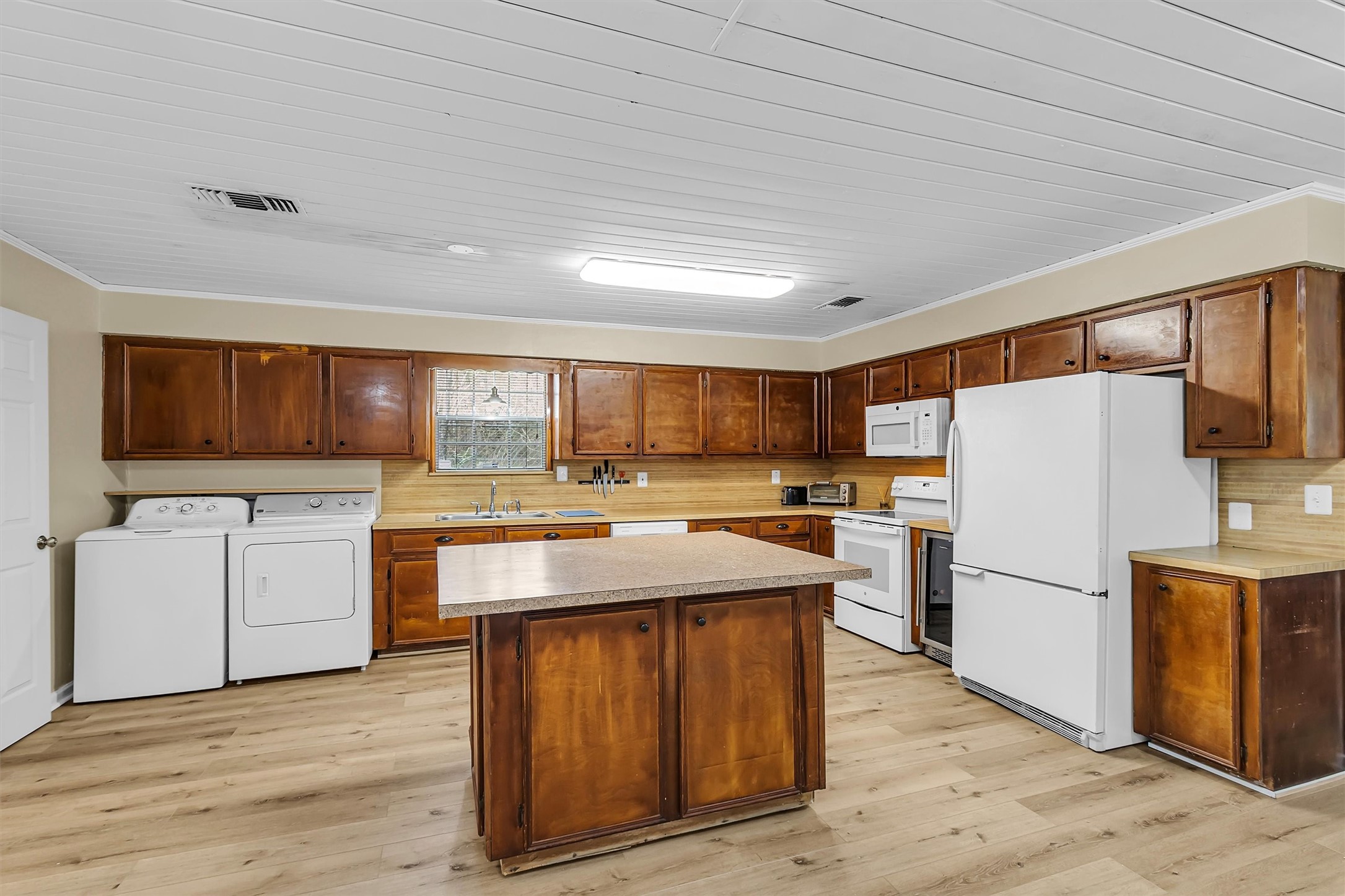 95 Main Street Huntsville, TX 77340 - Photo 10 of 30 a kitchen with refrigerator and cabinets