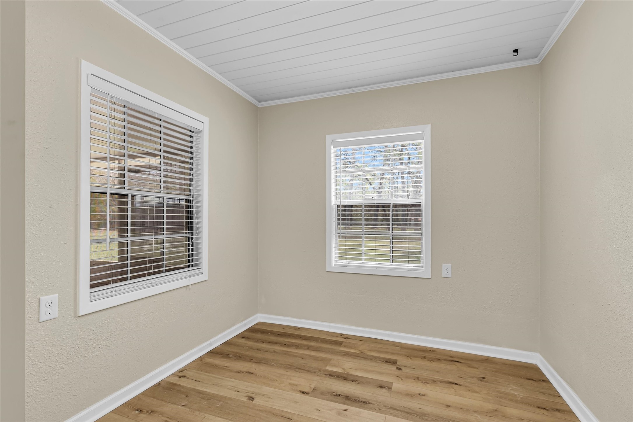 95 Main Street Huntsville, TX 77340 - Photo 15 of 30 a view of an empty room with wooden floor and a window