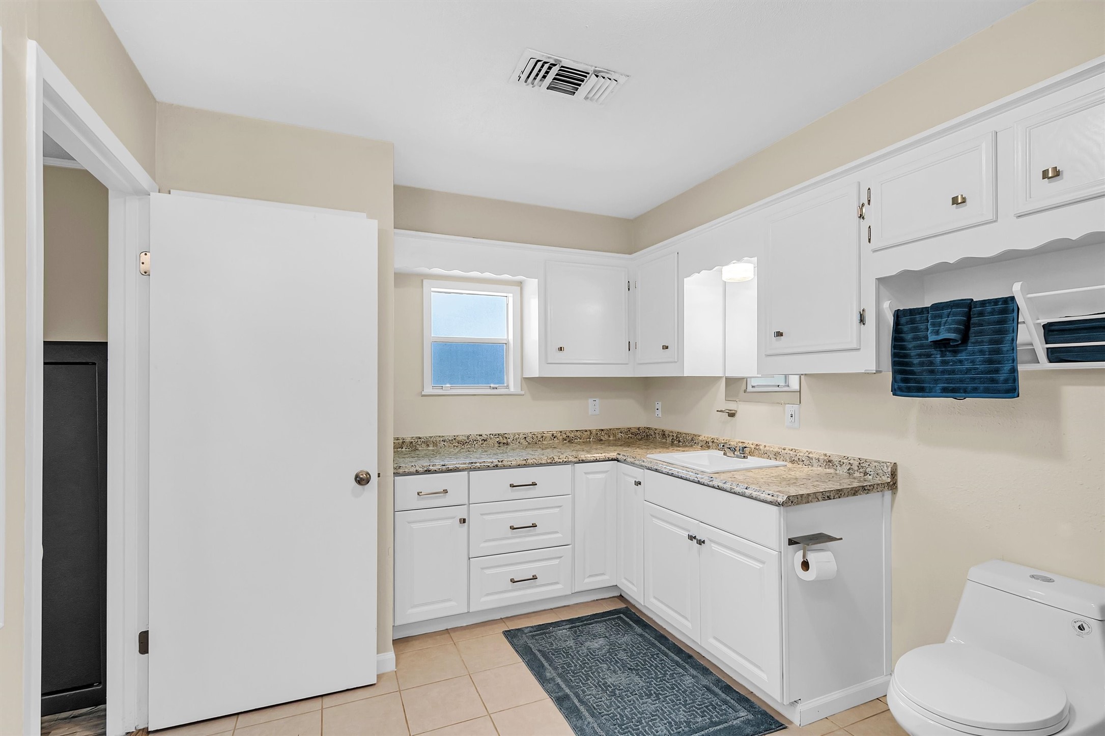 95 Main Street Huntsville, TX 77340 - Photo 18 of 30 a kitchen with white cabinets and white appliances