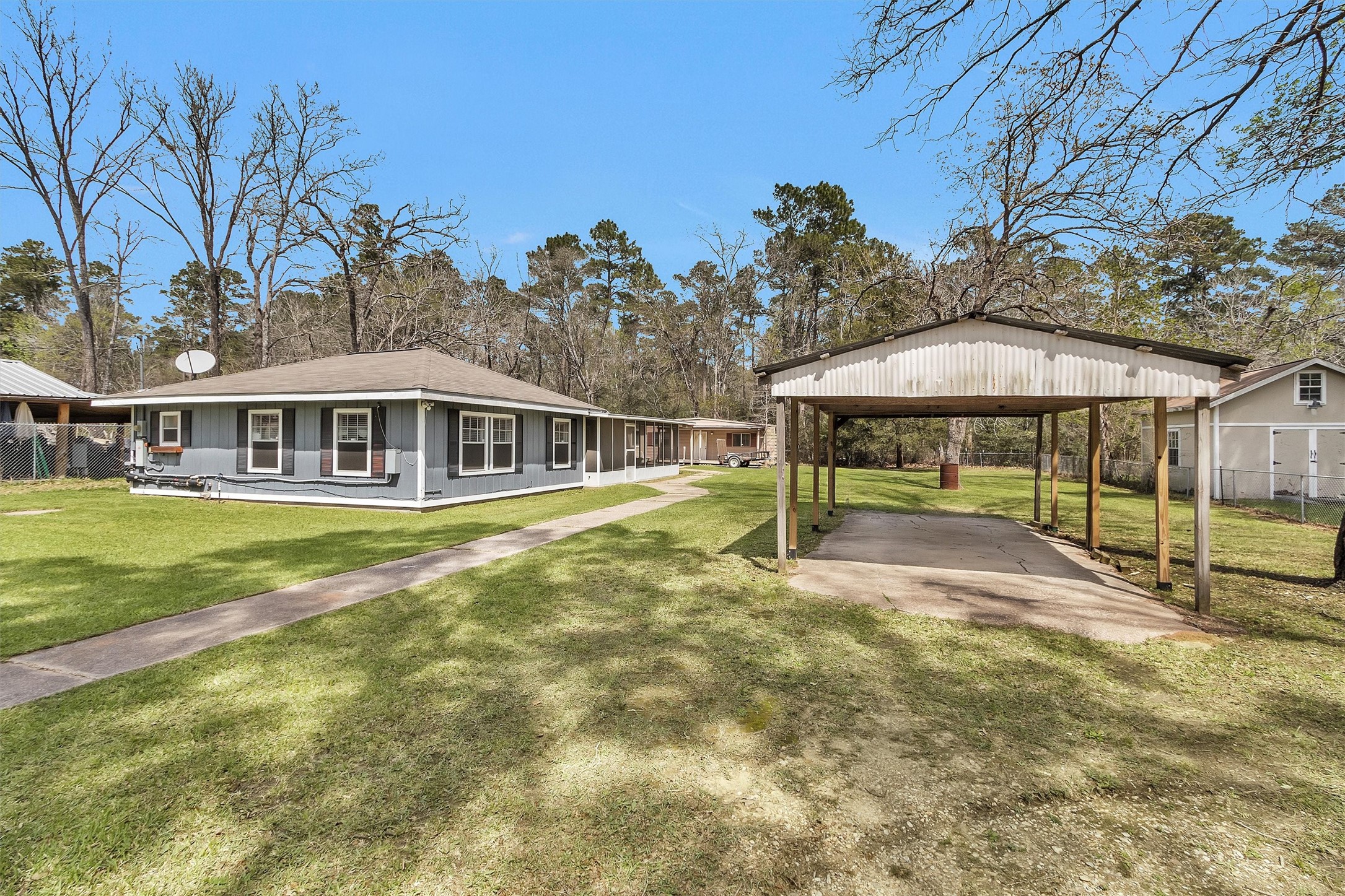 95 Main Street Huntsville, TX 77340 - Photo 3 of 30 a view of a house with a backyard and a patio