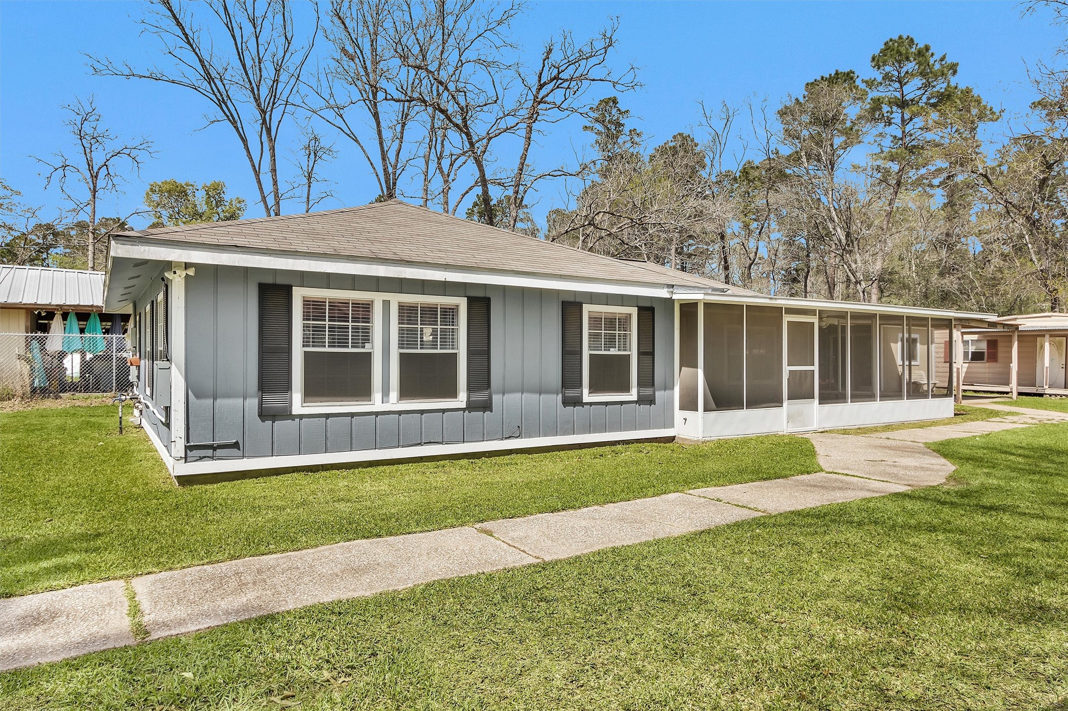 95 Main Street Huntsville, TX 77340 - Photo 5 of 30 a house that has a big yard with potted plants and big trees