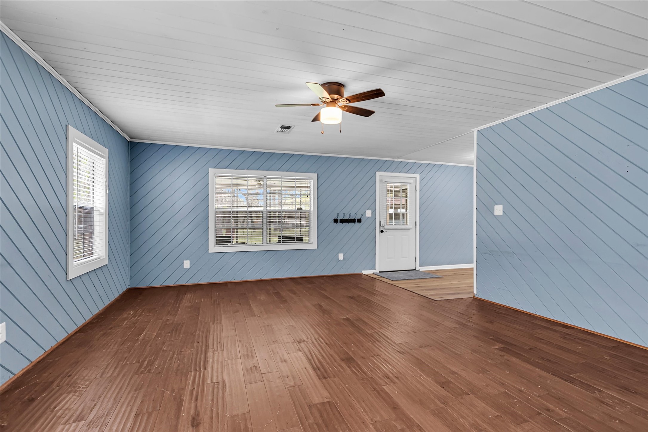 95 Main Street Huntsville, TX 77340 - Photo 8 of 30 a view of an empty room with a window and wooden floor