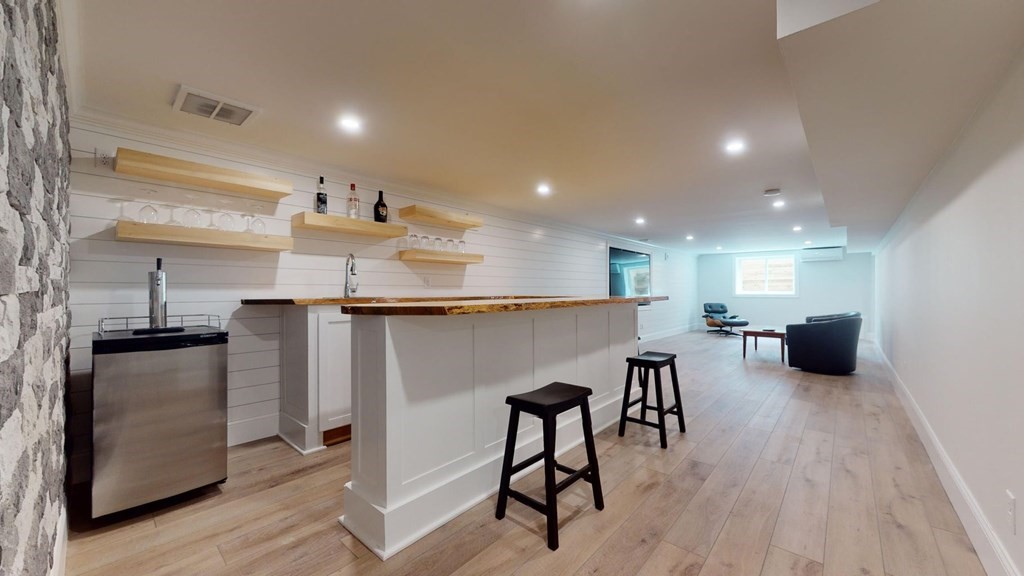 290 Riverview Lane Barnstable, MA 02632 - Photo 7 of 31 a open kitchen with kitchen island a refrigerator a stove a sink and a dining table with wooden floor