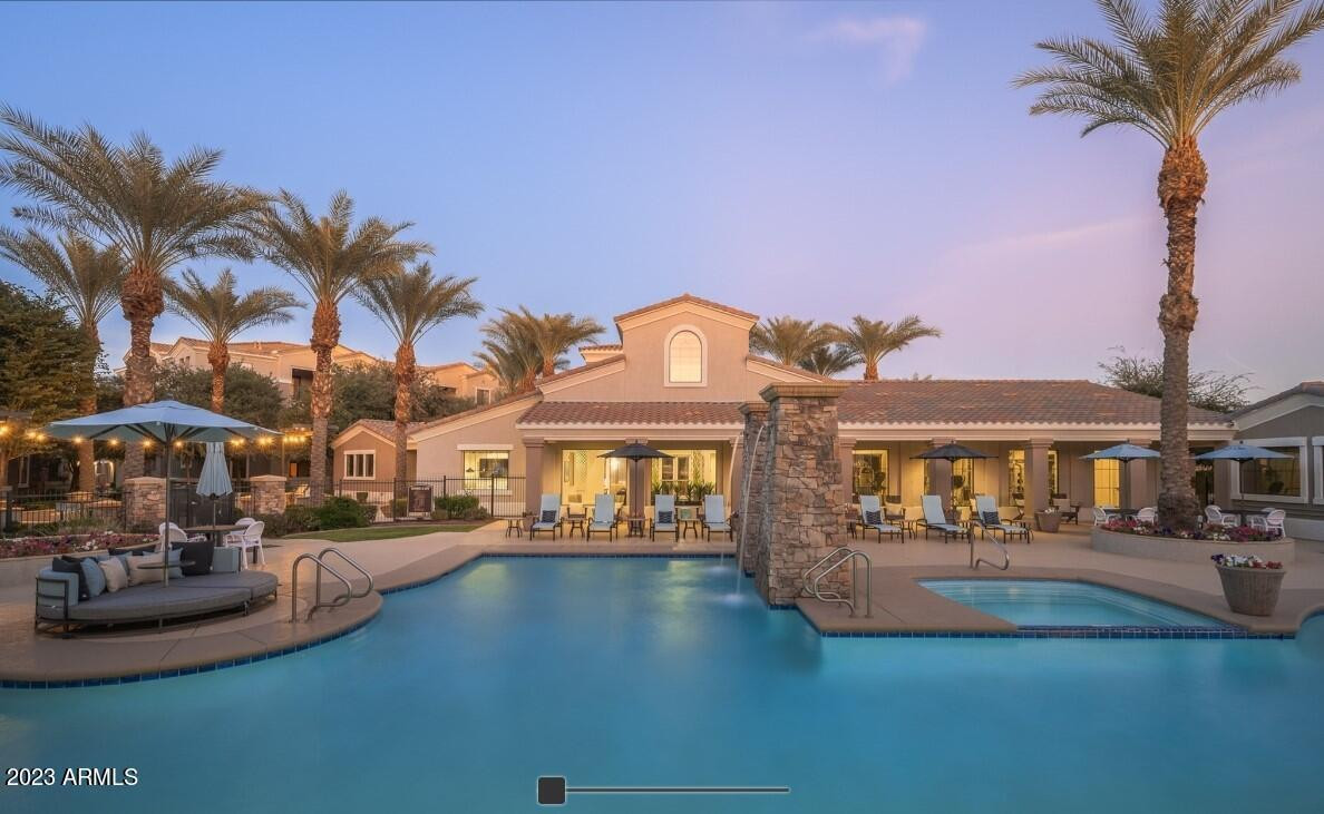 a front view of a house with swimming pool yard and outdoor seating