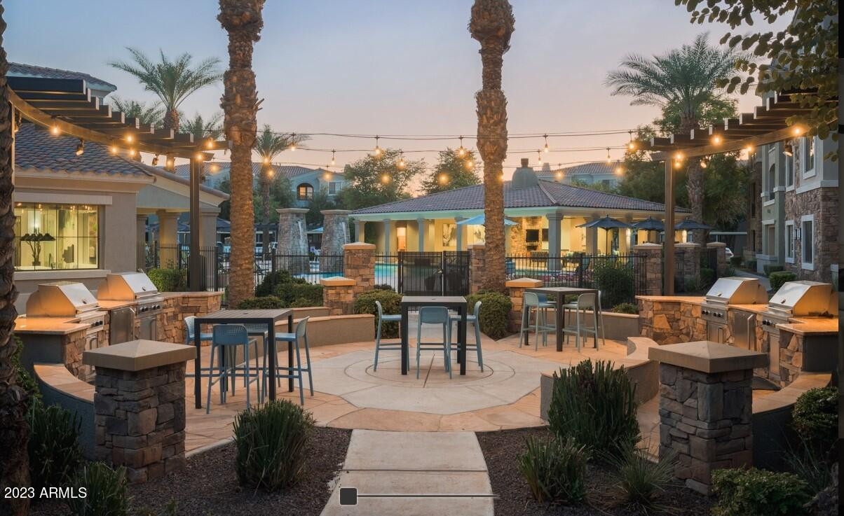 2910 South Greenfield Road, Unit B3B Gilbert, AZ 85295 - Photo 11 of 13 a view of a patio with couches table and chairs potted plants and palm tree