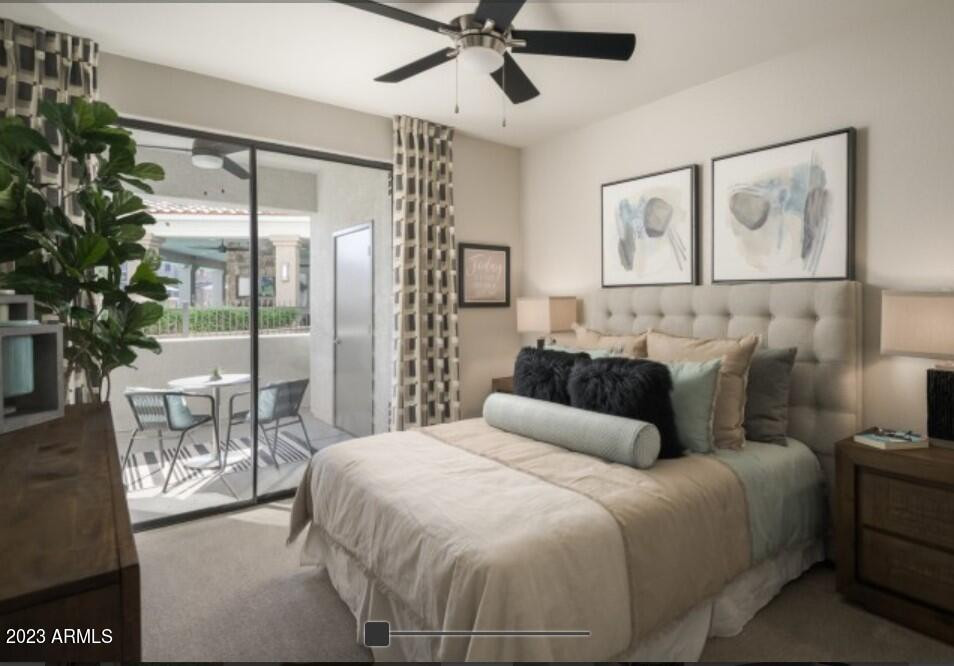 2910 South Greenfield Road, Unit B3B Gilbert, AZ 85295 - Photo 6 of 13 a bedroom with a large bed and a chandelier