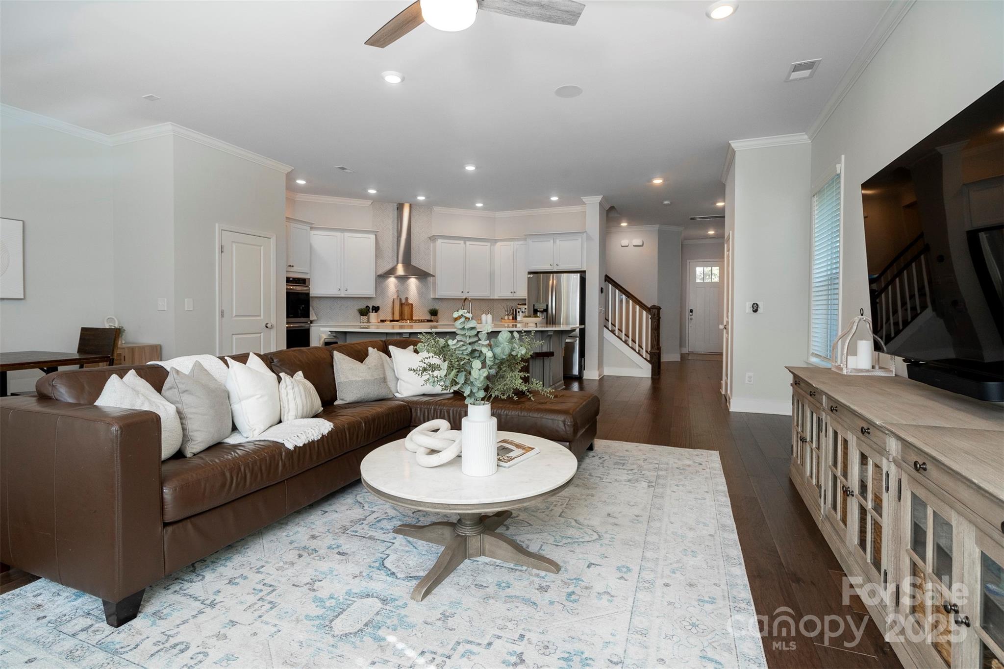 2523 Lola Avenue Charlotte, NC 28205 - Photo 11 of 40 a living room with furniture kitchen view and a wooden floor