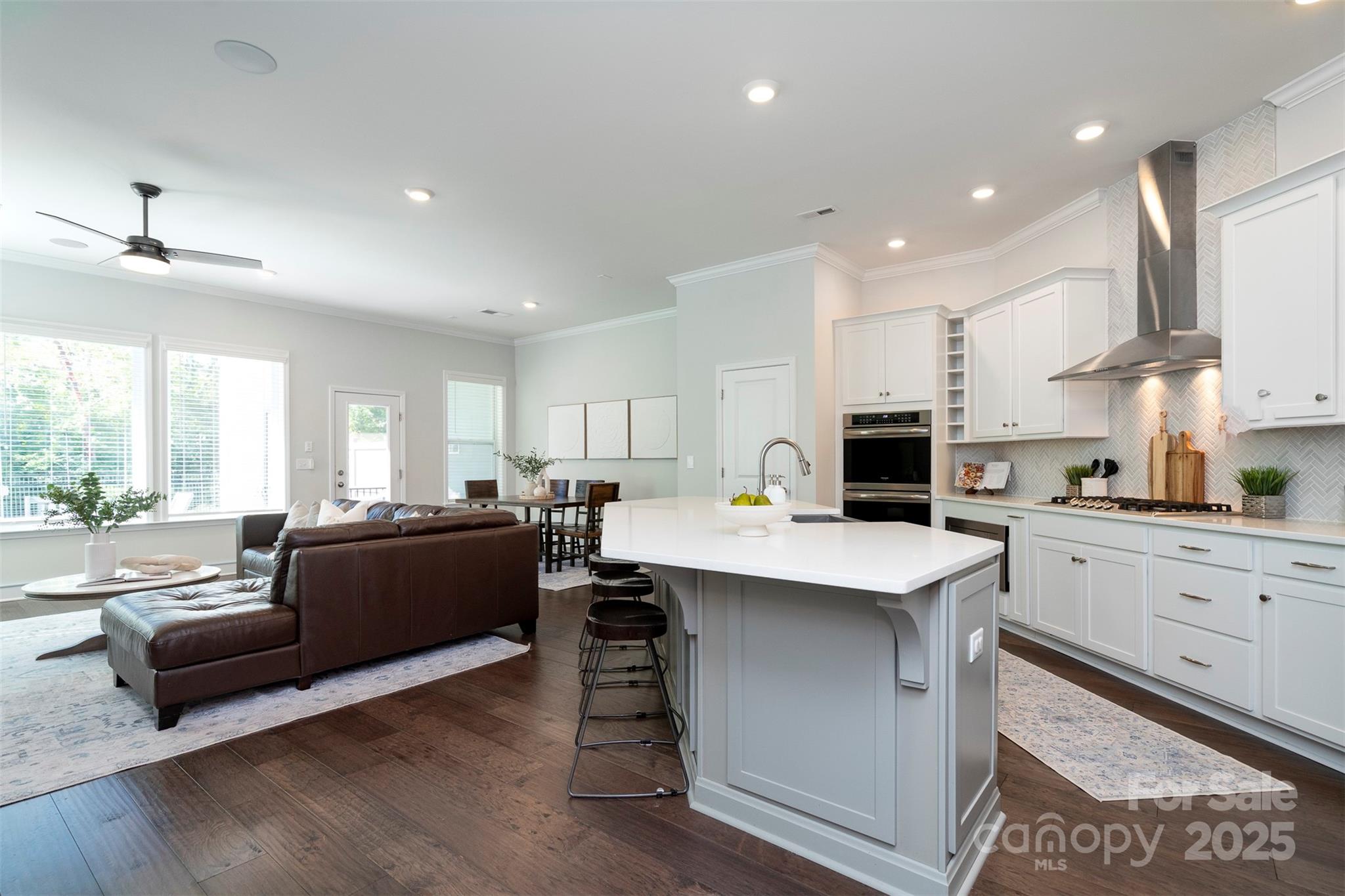 2523 Lola Avenue Charlotte, NC 28205 - Photo 13 of 40 a kitchen with stainless steel appliances kitchen island granite countertop a sink dishwasher a stove and white cabinets with wooden floor