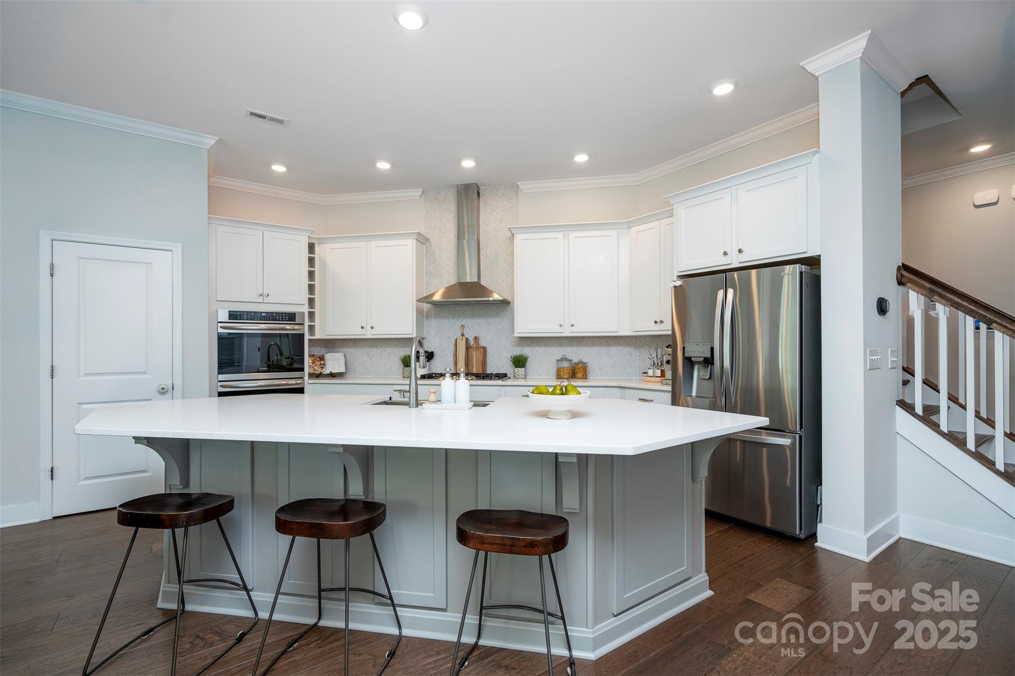 2523 Lola Avenue Charlotte, NC 28205 - Photo 14 of 40 a kitchen with stainless steel appliances granite countertop a sink a stove a refrigerator and white cabinets with wooden floor