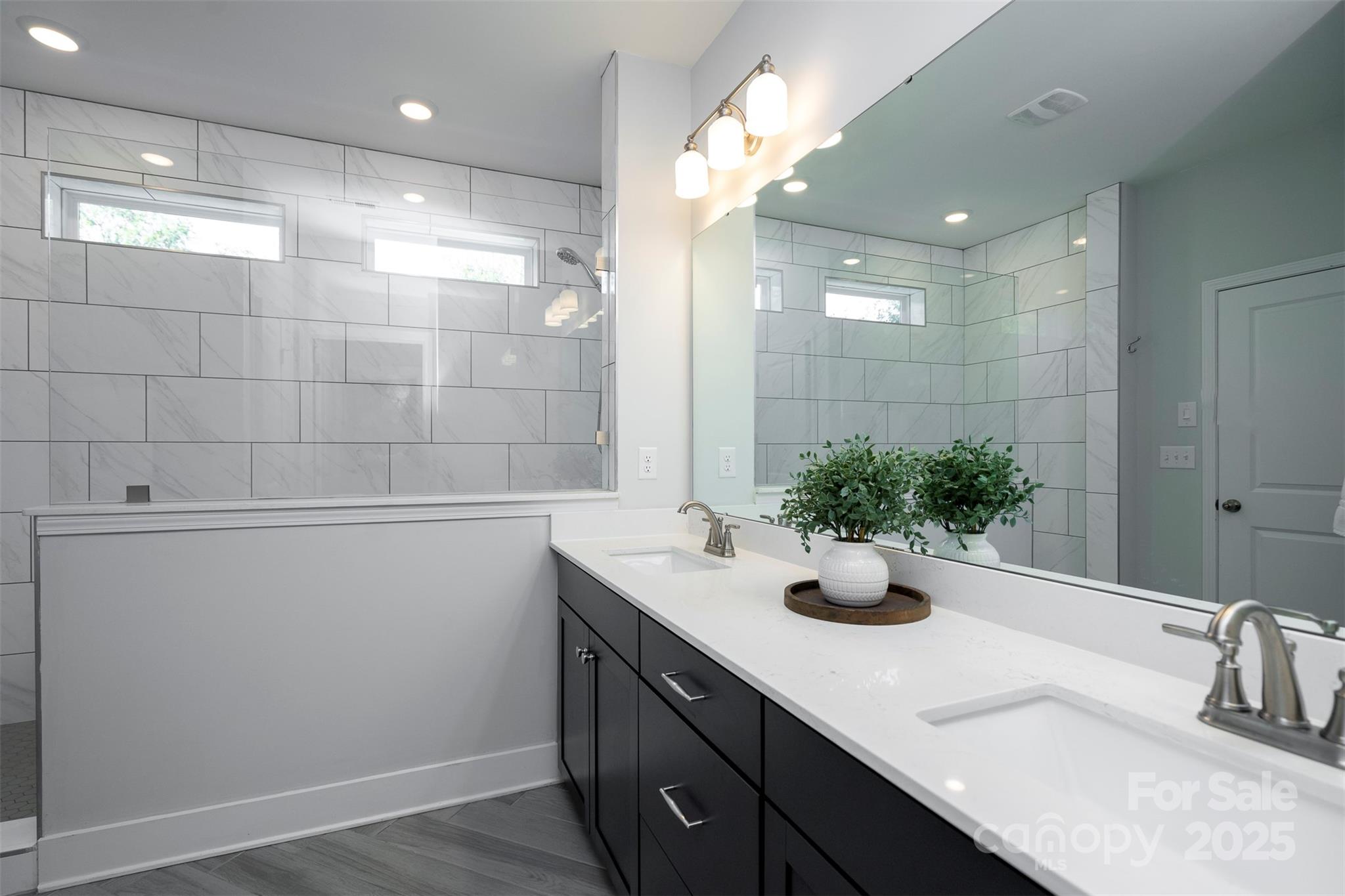 2523 Lola Avenue Charlotte, NC 28205 - Photo 23 of 40 a bathroom with a sink and a mirror