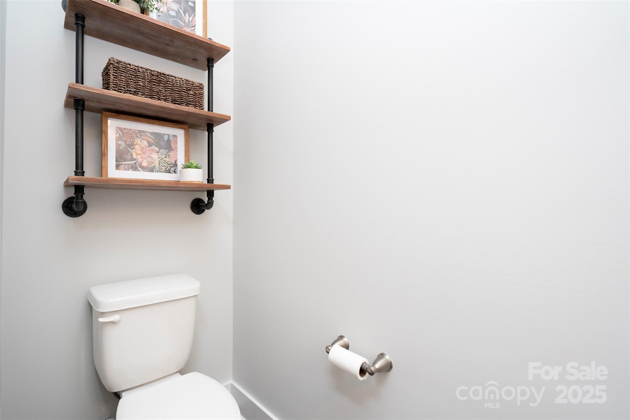 2523 Lola Avenue Charlotte, NC 28205 - Photo 6 of 40 a white toilet sitting next to a bathroom sink