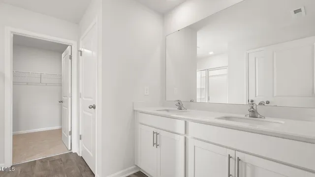 a bathroom with a sink double vanity and a mirror